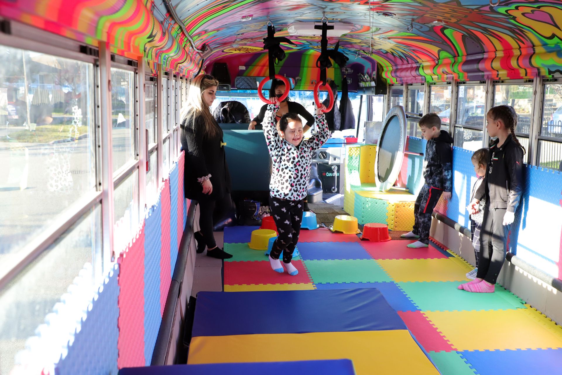 Kids mid-tumble beside the bus